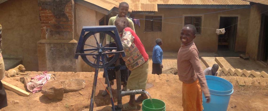 Children gathering water at a well.